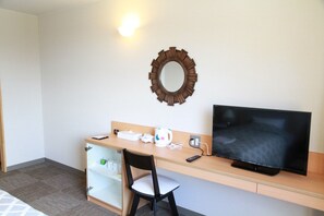 Enjoy a minimalist retreat with a desk, flat-screen TV, and comfortable chair.