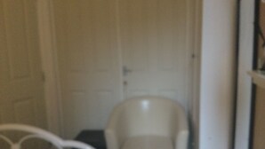 A bathroom with a white toilet, a white sink, and a white shower area. - TDM Bachelot Lettings Ltd (London)