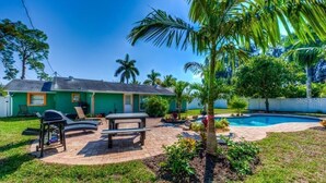 A house with a backyard patio, a pool, and a lawn. - "Barracuda" (Bradenton)