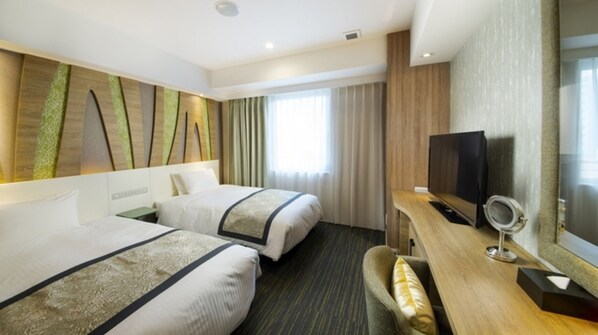 Relax in this stylish room with two single beds, a flat-screen TV, and a cozy seating area.