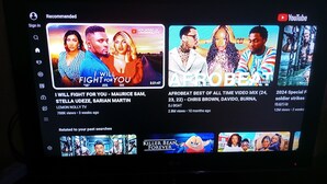 A YouTube interface with recommended videos, including 'I WILL FIGHT FOR YOU' and 'AFROBEAT BEST OF ALL TIME VIDEO MIX'. - Annex House For Rent (Serrekunda)