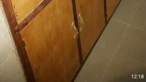 A kitchen with a stainless steel sink, wooden cabinets, and a microwave. - Annex House For Rent (Serrekunda)