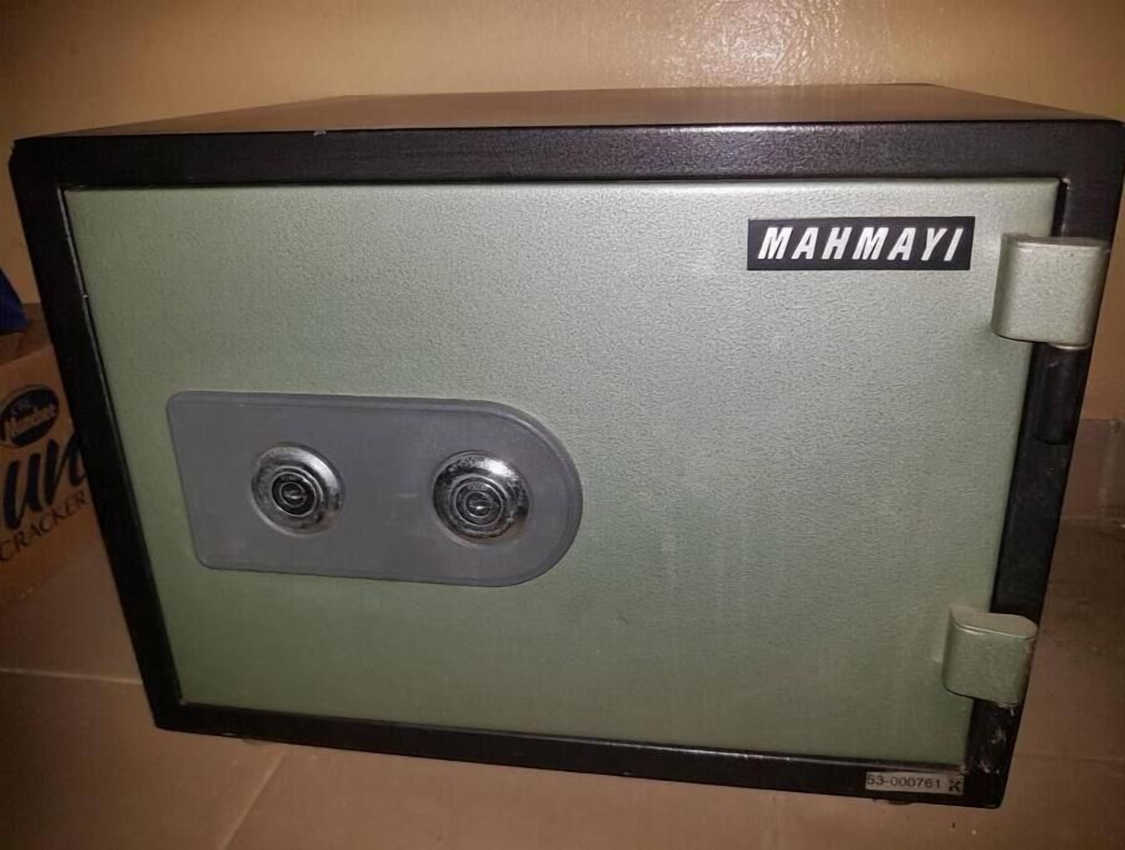 A green metal safe with a lock and a keyhole.