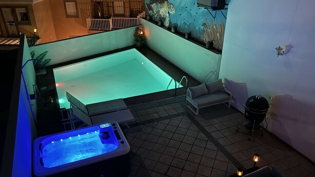 A rooftop pool area with a hot tub, seating, and a mural. - NEW: Fantastic Holiday Villa swimming pool and jacuzzi  2-30 (Arguineguin)