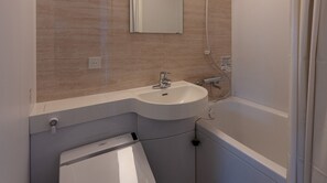 A bathroom with a sink, mirror, and bathtub. - Smoking Single room Standard plan 3 minutes wa / Hakusan Ishikawa (Hakusan)