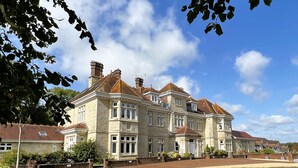 A large, historic building with multiple stories, stone facade, and traditional architecture. - 2 Shanklin Manor (Shanklin)