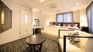 Relax in this stylish room with a large bed, comfortable sofa, and convenient workspace.