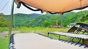 A tented area with a view of green hills and a small building in the background. - Nonsmoking Special offer Compact Japanesestyle / Aizuwakamatsu Fukushima (Aizuwakamatsu)