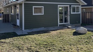 A single-story house with a gabled roof, a front door, and two windows. - Cozy Home in Historic Helper Utah, near park, pool, Utah Aggies baseball field. (Helper)