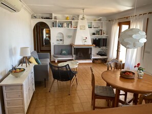 Cozy living space with a comfortable seating area, dining table, and television.