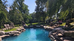 A clear blue pool surrounded by rocks and trees. - Spectacular Historic Mansion w/Pool&Tennis (Goshen)