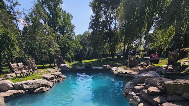 A clear blue pool surrounded by rocks and trees. - Spectacular Historic Mansion w/Pool&Tennis (Goshen)