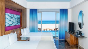 A hotel room with two beds, a TV, a desk, and a view of the beach. - Altitude by Krystal Grand Los Cabos – All Inclusive (San José del Cabo)