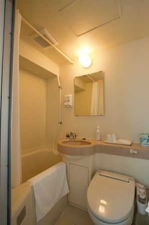 Bathroom features a sink, toilet, shower, hand dryer, and soap dispenser.