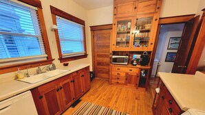 A kitchen with wooden cabinets, a microwave, and a stove.