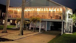 A modern building with a glass facade and a covered outdoor area. - Island Oasis Steps From the Sugar Sand Beach (Fort Myers Beach)