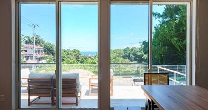 House surrounded by trees with a dog run / Kamogun Shizuoka