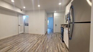 A modern kitchen with a stainless steel refrigerator, a microwave, and a dishwasher.