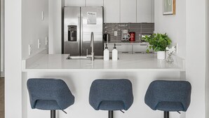 A modern kitchen with a stainless steel refrigerator, a coffee maker, and a potted plant. - Urban Retreat | Free WiFi+Parking, Walk to Stadium (Charlotte)