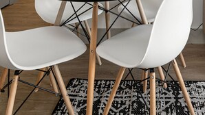 A dining area with a round table, white chairs, and a framed abstract painting on the wall. - Urban Retreat | Free WiFi+Parking, Walk to Stadium (Charlotte)