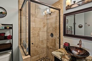 A bathroom with a glass shower enclosure, a marble sink, and a large mirror. - 1 Mi to Trails: Pet-Friendly Home in West Sedona! (Sedona)