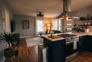 A modern kitchen with a central island, stainless steel appliances, and a large window. - [C] Private Country Retreat 10 Acres + 4 Min to Lawrence (Lawrence)
