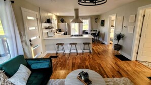 A modern kitchen with a central island, bar stools, and a dining area with a table and chairs. - [C] Private Country Retreat 10 Acres + 4 Min to Lawrence (Lawrence)