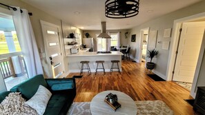 A modern kitchen with a central island, bar stools, and a dining area with a table and chairs. - [C] Private Country Retreat 10 Acres + 4 Min to Lawrence (Lawrence)