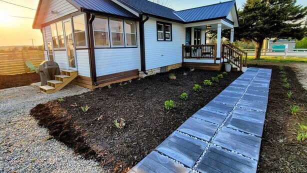 A single-story house with a covered porch, a small front yard with a pathway, and a garage. - [C] Private Country Retreat 10 Acres + 4 Min to Lawrence (Lawrence)