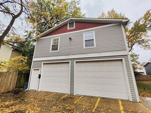 Building exterior; entry door at left with parking steps away