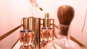 A bar setup with copper mugs and a metal pitcher on a reflective surface. - [1] StayAwhile: The Pink Retreat. 2-Min Walk to Mass! (Lawrence)