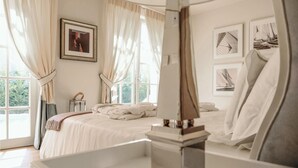 A bedroom with a bed, a bedside table, a mirror, and a window with curtains. - Beautiful home in Vabriga (Vabriga)