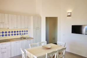 Dining - Three-room apartment sea view with 6 beds, approximately 51 m2, living room with kitchenette, double sofa bed, double bedroom, cetra with two single beds, bathroom with shower cubicle. <br>Arranged in a horseshoe shape around the swimming pool, they have (Badesi)