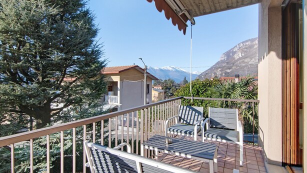A balcony with outdoor furniture, a view of a mountain, and a building with a red roof. - Holiday Home "Casa Lierna" with Private Terrace, Balcony and Wi-Fi (Lierna)