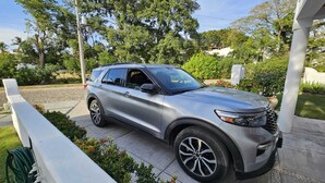 A silver SUV parked on a driveway with a white fence and greenery in the background. - La Puntilla, Luxury 3-bedroom, 3-bath home with heated pool in gated community (La Cruz de Huanacaxtle)
