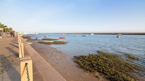 A waterfront promenade with a paved walkway, boats on the water, and a distant shoreline. - Holiday Apartment "Estrela Do Mar" with Wi-Fi (Santa Luzia)
