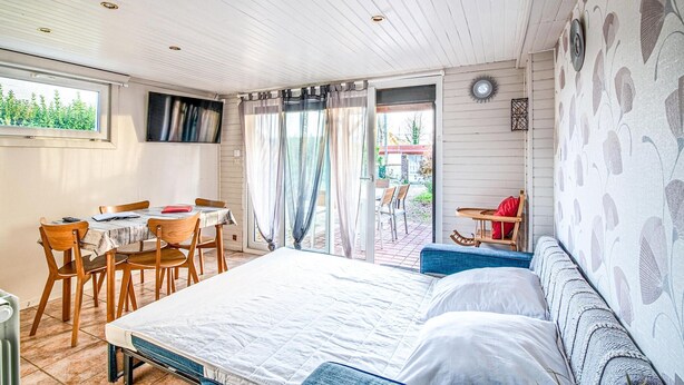A room with a bed, a table with chairs, a window, and a view of the outside. - Awesome home in Criquetot-l'Esneval (Criquetot-l'Esneval)