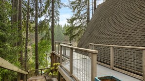 A wooden staircase leading to a viewing platform with a metal railing, surrounded by tall trees. - Stylish Lakefront Cabin Retreat, Sauna/Hot tub & Cold Plunge (Gig Harbor)