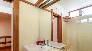 A bathroom with two sinks, a mirror, and a window.