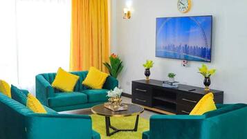 Deluxe Apartment | Living area | 40-inch LED TV with satellite channels