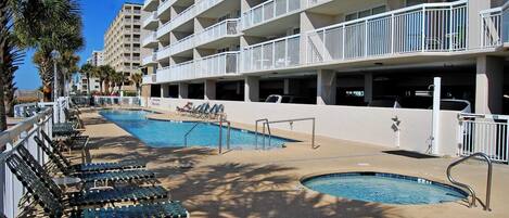 Um hotel com área de piscina, várias varandas e garagem.
