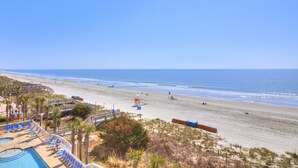 A beach resort with a swimming pool, beach chairs, and a lifeguard station. - Views for days! Oceanfront 3 Bedroom 3 Bath Crescent Shores North Myrtle Beach (North Myrtle Beach)