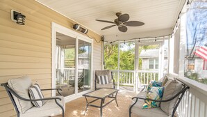A covered porch with a ceiling fan, two chairs, a table, and a sofa. - 2 Incredible Units Equal Double the Amenities! Lazy Mermaid (Folly Beach)
