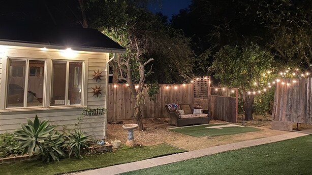 A backyard with a patio, string lights, and a wooden fence. - Vintage home near Rose Bowl & JPL/NASA. So many trails great for active folks    (Altadena)