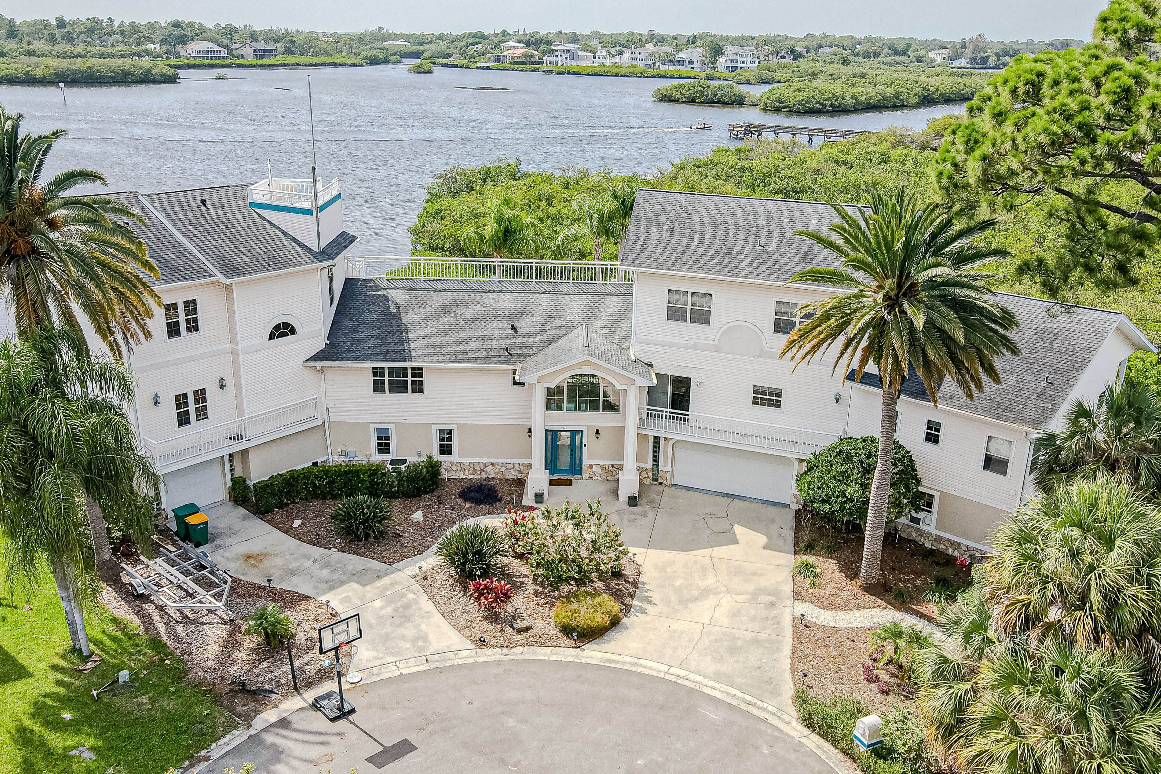 Luxurious waterfront estate with dock, pool, firepit, game room & great views