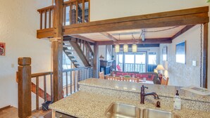 A kitchen with granite countertops, stainless steel sink, and wooden beams. - 1 Mi to Stagecoach Lift! Homey Tahoe Townhome (Stateline)