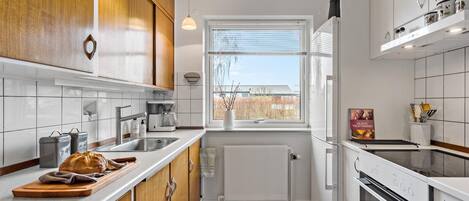 Fridge, stovetop, dishwasher, coffee/tea maker