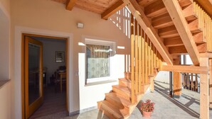 A wooden staircase leading to an upper level, a door to a room, and a window with a view. - 2 bedroom gorgeous home in Lamon (Lamon)