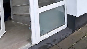 A white exterior wall with a sliding glass door leading to a staircase. - Apartment 'Apartement Kingsize' with Shared Terrace and Wi-Fi (Duisburg)