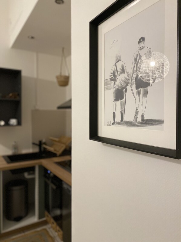 A framed black and white photograph on a wall.